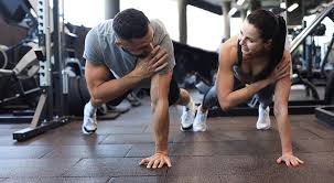 Toning Bingo Wings: Your Ultimate Guide to Sculpting Sleek Arms at the Gym 3 Fitness trainer demonstrating arm toning exercises Warwickshire